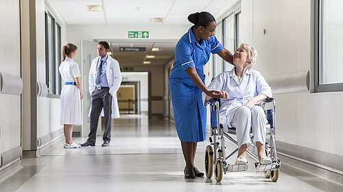 A nurse helping a patient in a wheelchair